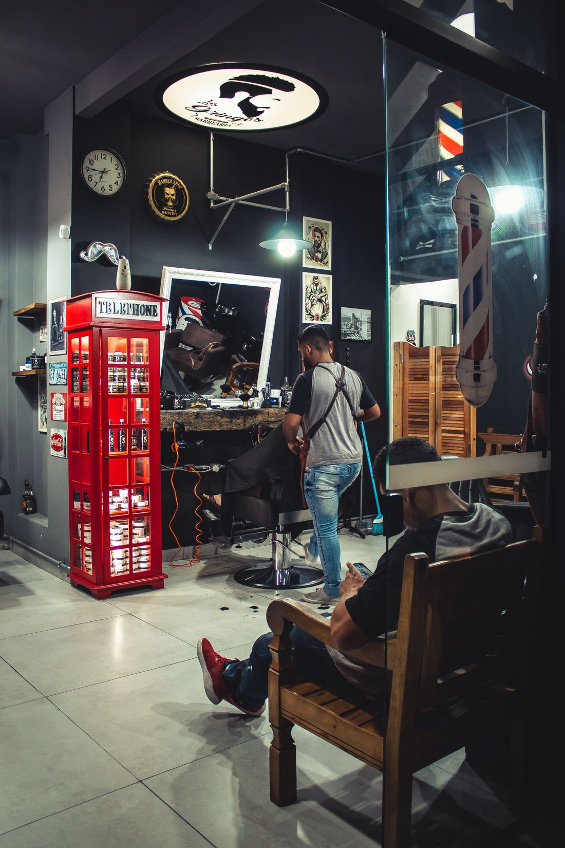 The barbershop street frontage beside a traditional red telephone box
