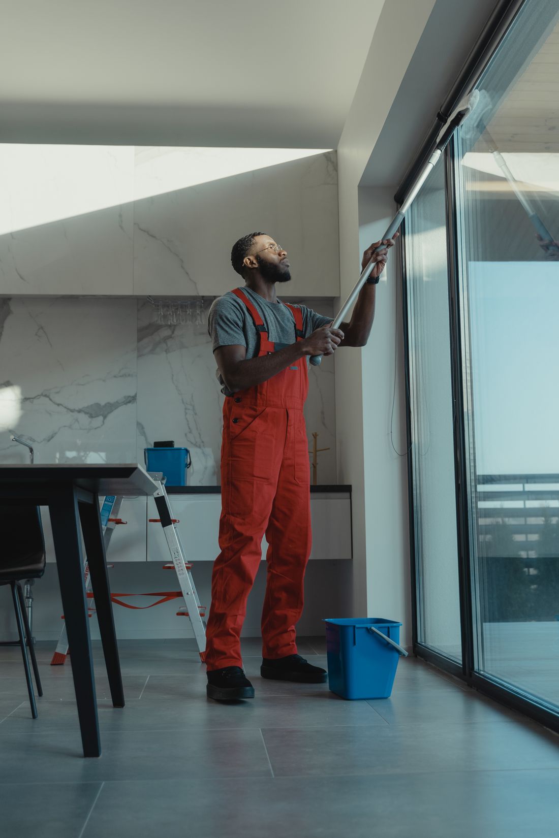 Cleaning a large window in a modern home for a streak-free finish